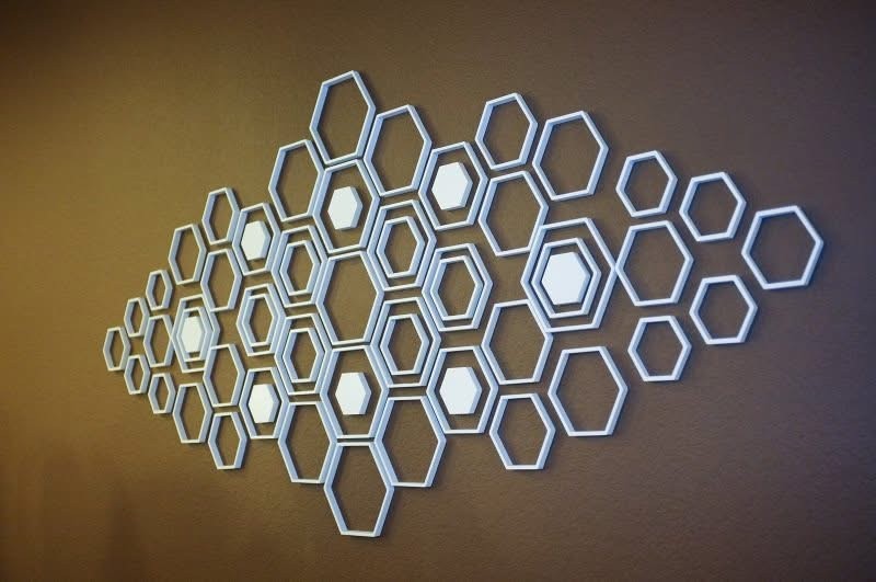 White hexagon wall art on a warm brown wall